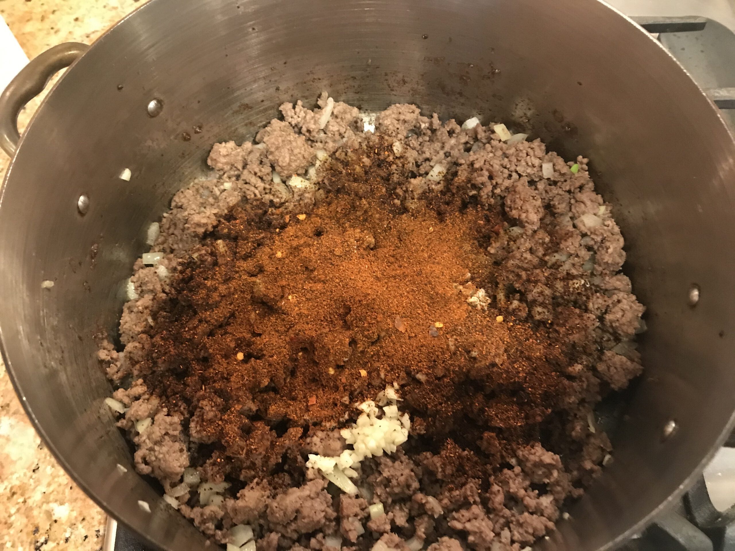 Spices and ground beef in pot